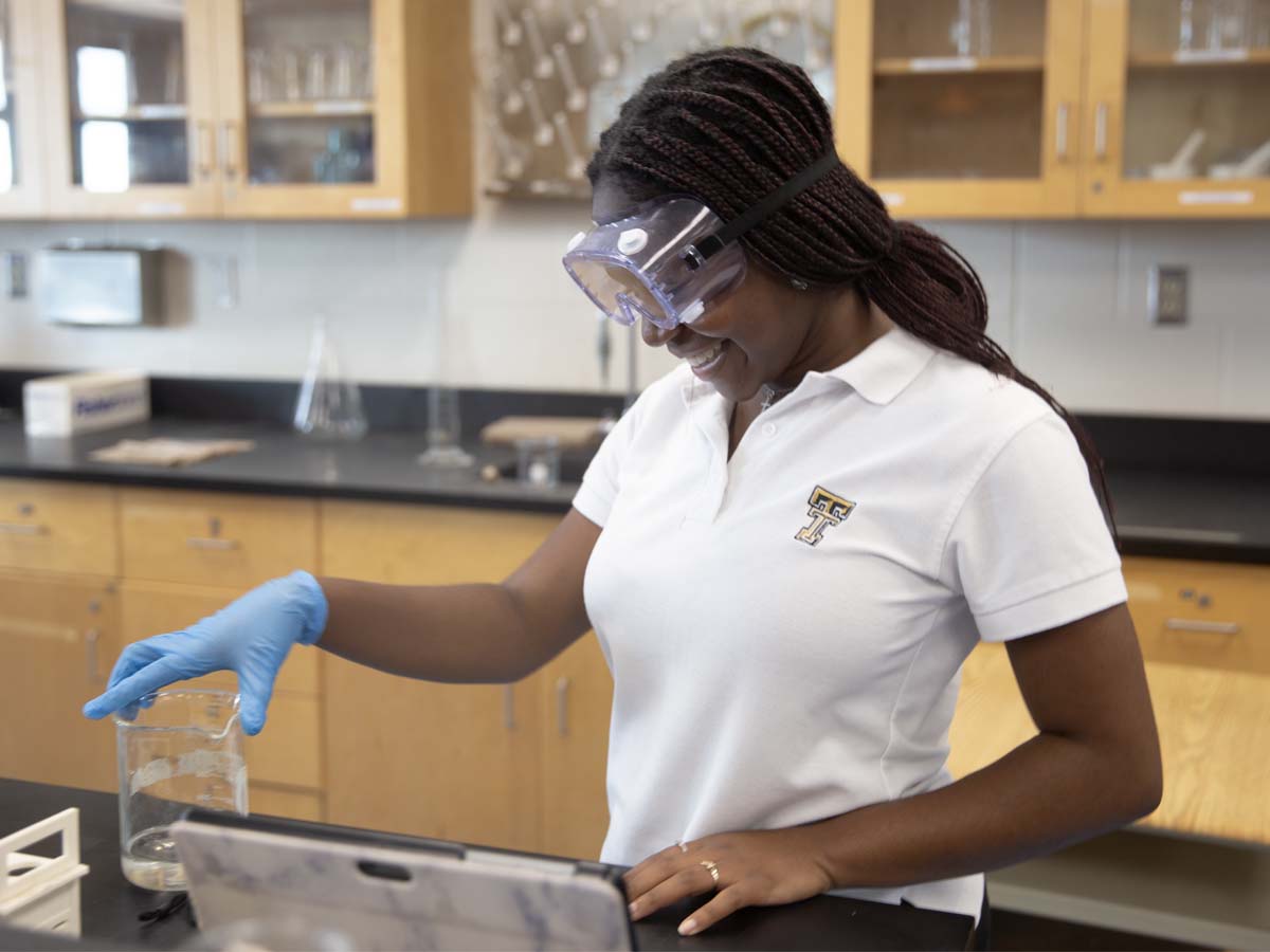 Holy Trinity Advanced Placement female student in science lab