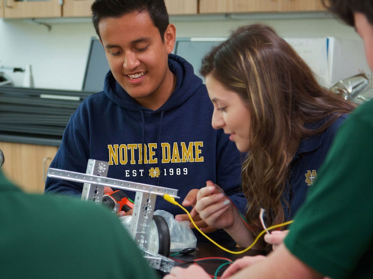 Candid photo of two Notre Dame students in Burlington working together in a tech lab